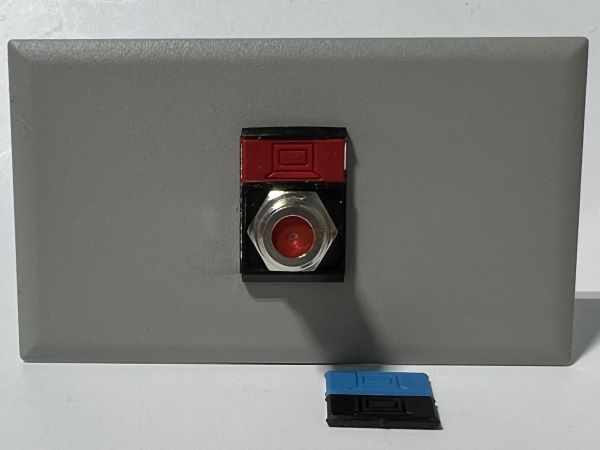 Telecom Plate with single Siemon™ Flat MAX® F-Type Coaxial Connector - Installed - Front View - Gray. Shown with additional color icons