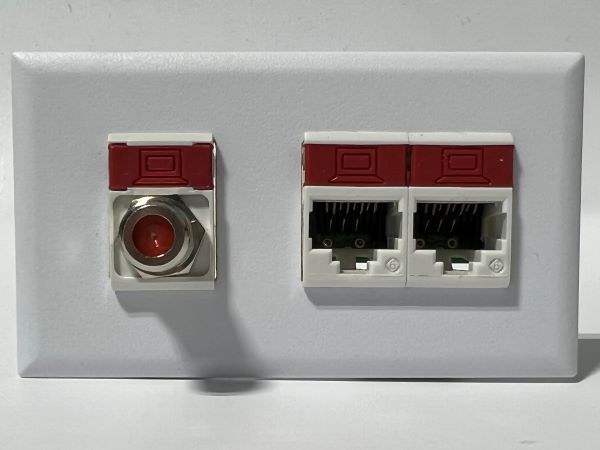 Telecom Plate with single Siemon™ Flat MAX® F-Type Coaxial Connector and 2 Siemon™ Flat MAX® RJ45 CAT6 connectors - Installed - Front View - White. Shown with additional color icons